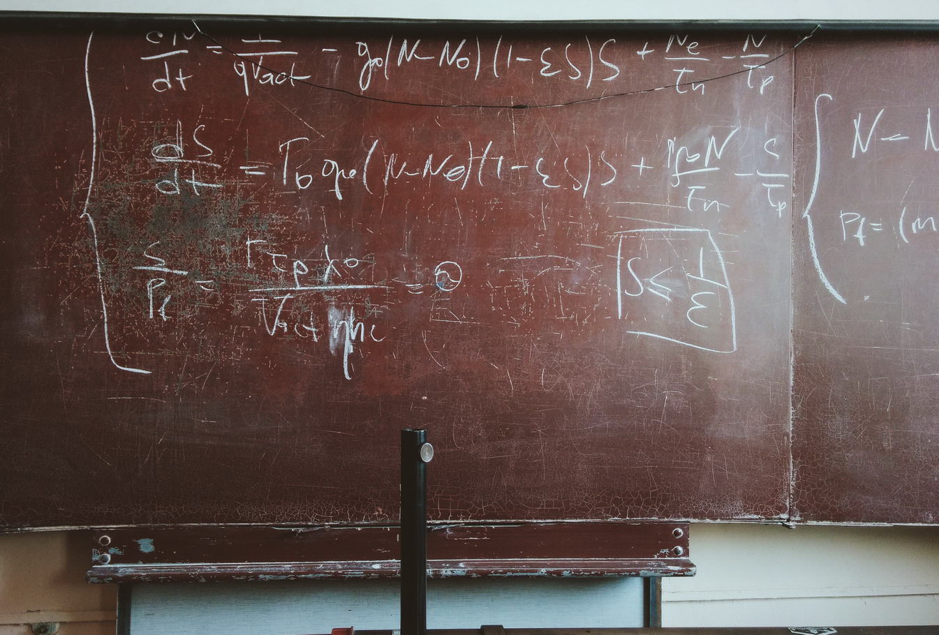 blackboard with differential equations written in chalk